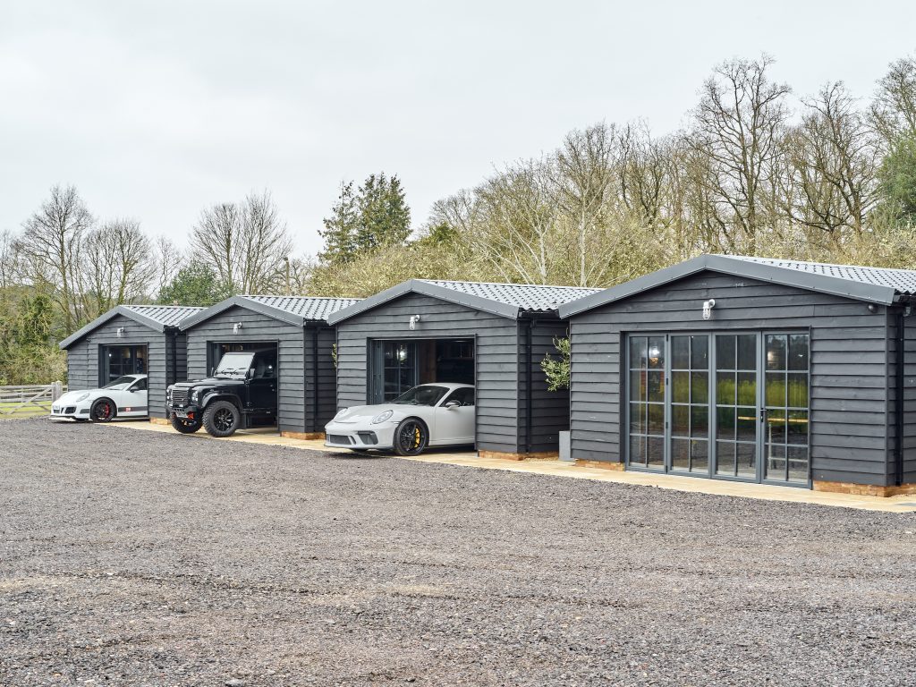 The Griffin project - luxury garage - luxury cars - grey wood exterior